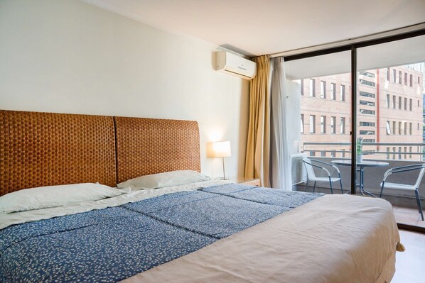 Relax in this cozy bedroom with a private balcony offering city views, perfect for unwinding after a day of exploring.