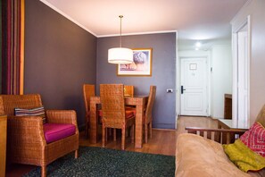 Relax in this cozy dining space with stylish wicker furniture and modern decor, perfect for intimate meals.