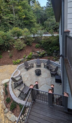 Patio and fire pit with Adirondack chairs from upper deck