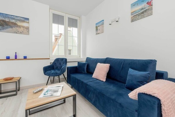 Living room with a sofa, coffee table and armchair.