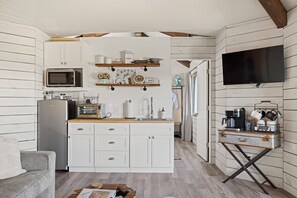 Stocked kitchenette with mini fridge and microwave