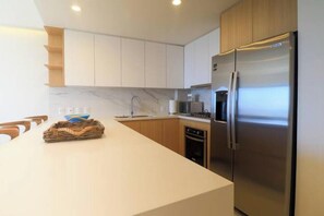 White quarts countertops, stainless steel appliances, double sink, dishwasher...