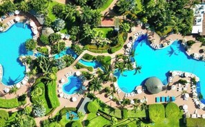 Swimming pools, abundant green areas, private beach access.