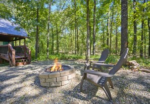 Embrace the tranquility of this cabin's exterior, nestled peacefully among the trees.