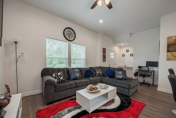 Cozy Living Room with 65inch Smart TV and informed reading materials