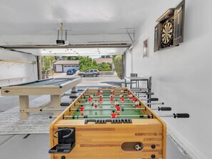 Foosball and darts in playroom in garage