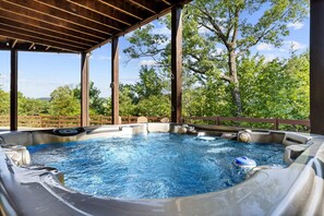 Unwind in the hot tub with a panoramic view of the mountains and trees, perfectly situated by the deck
