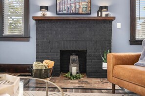 Adding charm and character, the fireplace creates a warm focal point for the living room.