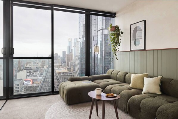 Open the windows and allow breezes to flow through the apartment. Glass window walls offer natural light throughout as you curl up with a book in the comfort of the stylish living area. 
