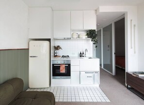 With a well-equipped kitchenette, you can easily prepare a dinner for two while enjoying a movie on the sofa.
