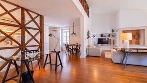 The spacious and charming living room is framed by large windows that let in plenty of natural light #decor #lisbon #airbnb #lovely #home