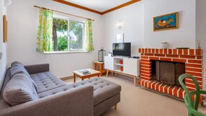 Our cozy living room offers a comfy sofa, a contemporary fireplace, and a charm of sunlight. Relax and watch your favorite shows in this perfect haven of comfort #pt #portugal #algarve #cozy #comfy #sunlight #relax