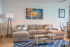 Spacious, modern living room area, with sleeper sofa. 