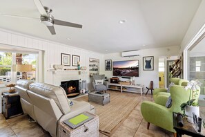Cozy and spacious living area with TV and fireplace