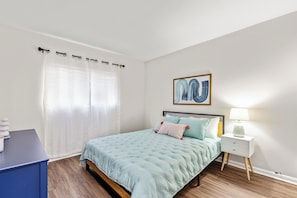 Bedroom 2 features a comfortable queen bed, providing a peaceful and restful space for guests.