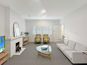 Living area with lovely finishes including plantation shutters