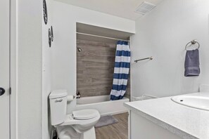 Start your day feeling energized in this bright and airy bathroom. The white tiles and walk-in shower create a clean and refreshing atmosphere.
