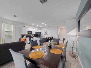 Spacious Downstairs Living Room with Dining Table and Comfortable Sofa