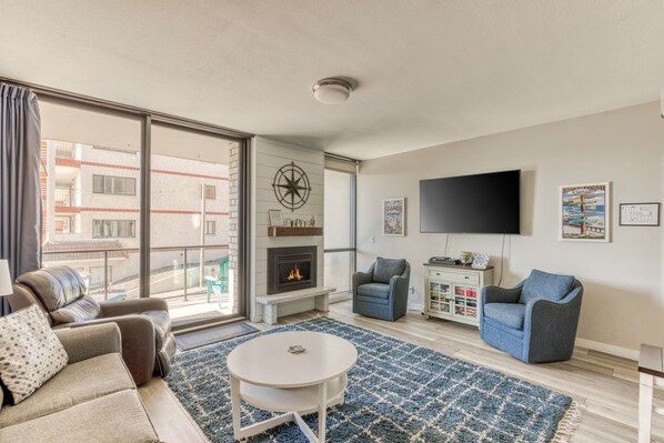 Cozy up by the fireplace and enjoy a movie night! Our comfy living space is perfect for relaxing together.