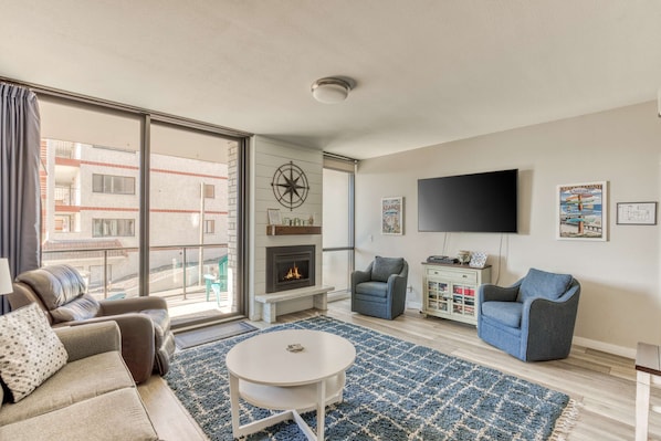Cozy up by the fireplace and enjoy a movie night! Our comfy living space is perfect for relaxing together.