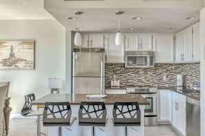 Functional kitchen providing essential appliances creating a clean and practical cooking space.