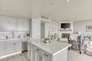 The island provides ample space to prep while also providing seating for company. Open floor plan means no one is missing out on the festivities!