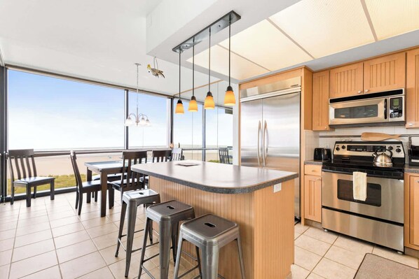 The island provides ample space to prep while also providing seating for company. Open floor plan means no one is missing out on the festivities!