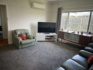 Large living area, arm chairs, with reverse cycle air conditioning, carpeted floor, large TV with DVD palyer and spare DVD's.