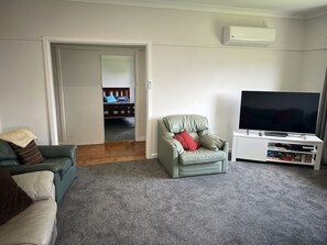 Large living area, arm chairs, with reverse cycle air conditioning, carpeted floor, large TV with DVD palyer and spare DVD's.