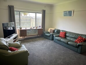 Large living area, arm chairs, with reverse cycle air conditioning, carpeted floor, large TV with DVD palyer and spare DVD's.