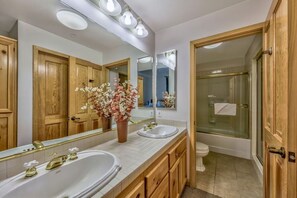 Enjoy the bright and clean bathroom equipped with a large vanity, plenty of storage, and a refreshing shower.