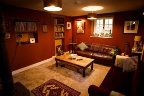 Snug and TV lounge with wood burning stove.