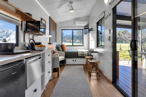 Open plan kitchen living and bed nook cleverly styled