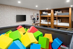 Let the fun begin! This playful bedroom features soft foam cubes for kids to jump, stack, and create—perfect for endless imagination and safe adventures