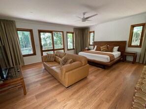 Bedroom 1 with ensuite, large walk-in wardrobe, separate smart TV & sofa