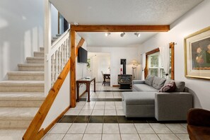 This inviting living room is the perfect place to curl up with a good book and a warm fire.