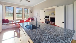 Kitchen has stainless appliances and a large center island with counter seating