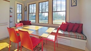 Dining area with large table, chairs and bench seating