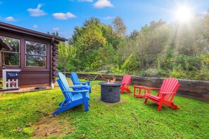 Relax around the firepit in the back yard.