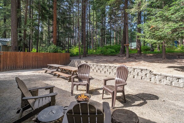 Gather round the propane firepit in the back yard space