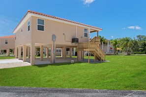 The Tarpon on stilts with parking space for cars and trailers under the house