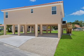 The Tarpon on stilts with parking space for cars and trailers under the house