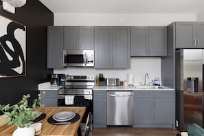 Fully equipped kitchen with all the tools you need for a perfect culinary experience. Enjoy the convenience of having everything at your fingertips!