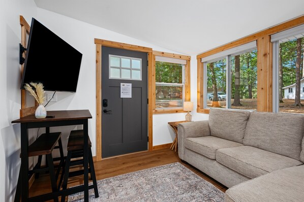 Living Room Retreat: Sun-drenched space with smart decor, perfect for relaxation and fun!
