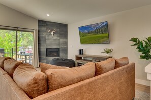 Living area with comfy couch, flat screen TV, and fireplace