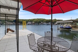 Private dock with seating under an umbrella, perfect for enjoying lakeside views and easy water access.