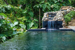 Relaxing waterfall connecting the nearby jungle to the private swimming pool.