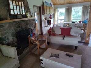 Large spacious living rooom with wood burning fireplace