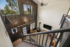 Welcome to our cozy retreat! Step into our spacious living room and be greeted by the warm glow of the crackling fireplace...