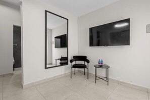 A comfortable seating area and a large TV for entertainment.